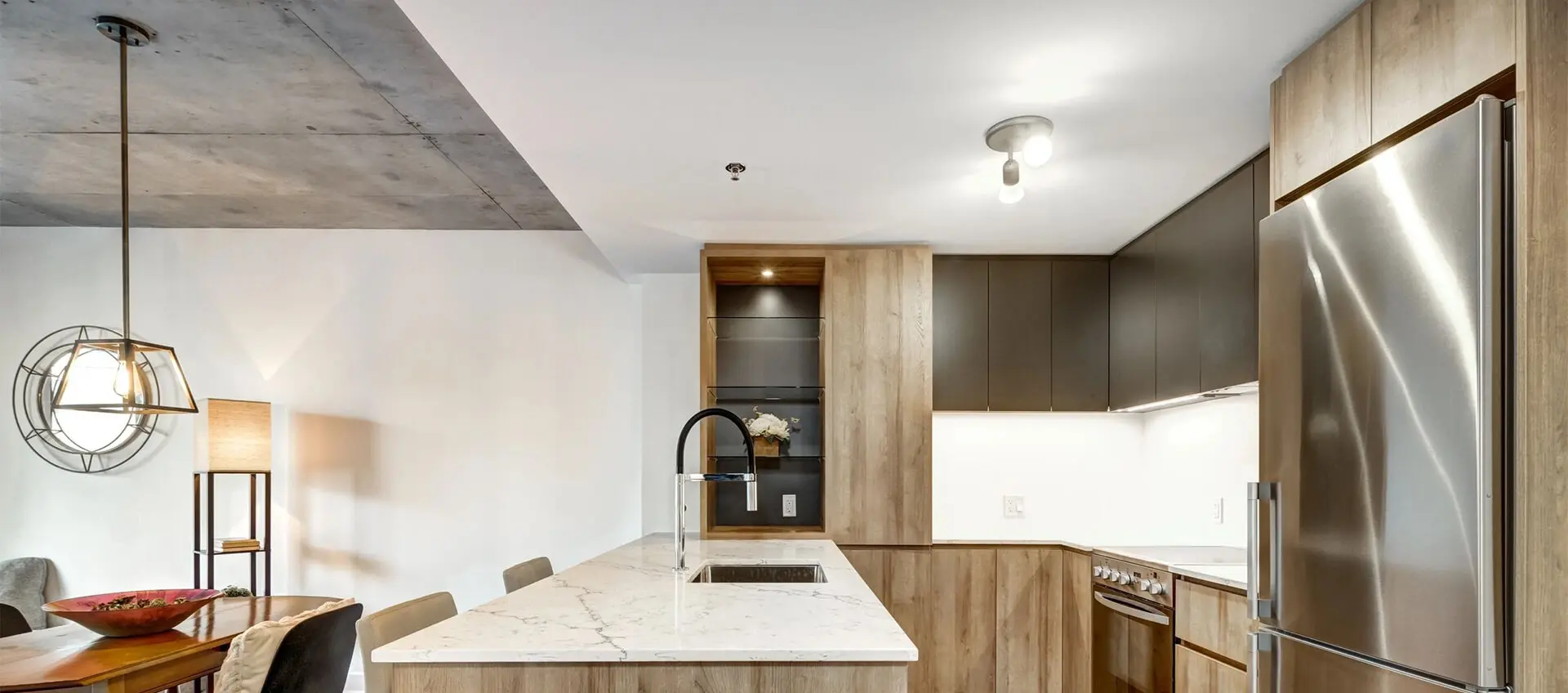 A kitchen with wooden cabinets and white walls.