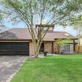 A house with a tree in front of it